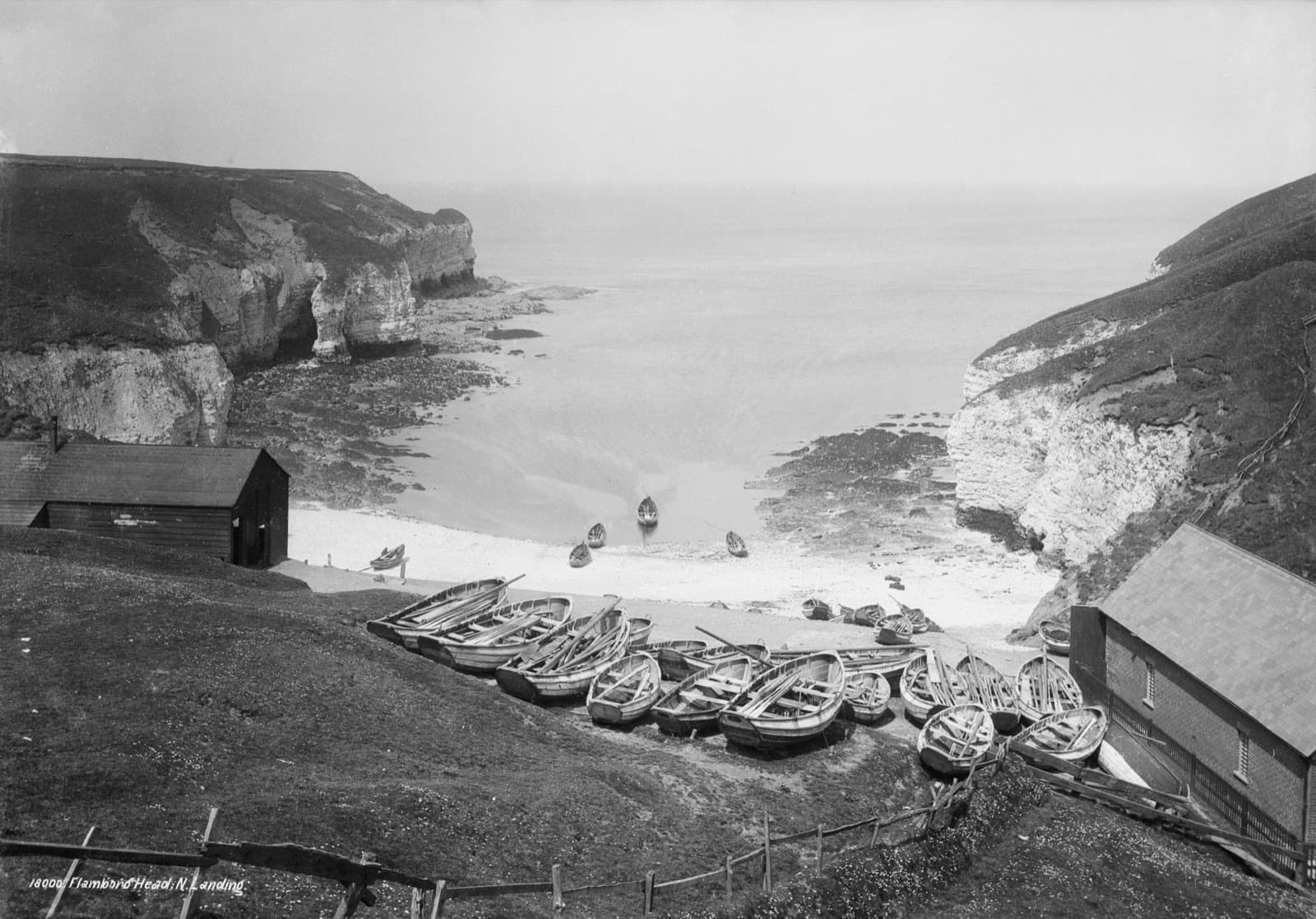 Victorian photograph of North Landing, Flamborough: fishing cobles drawn up on the beach beneath the chalk cliffs